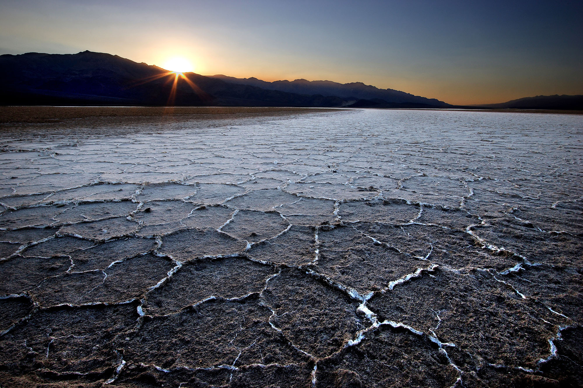 The Badwater Basin in Death Valley is a hot dried up salt lake full of mud cracks located below sea-level