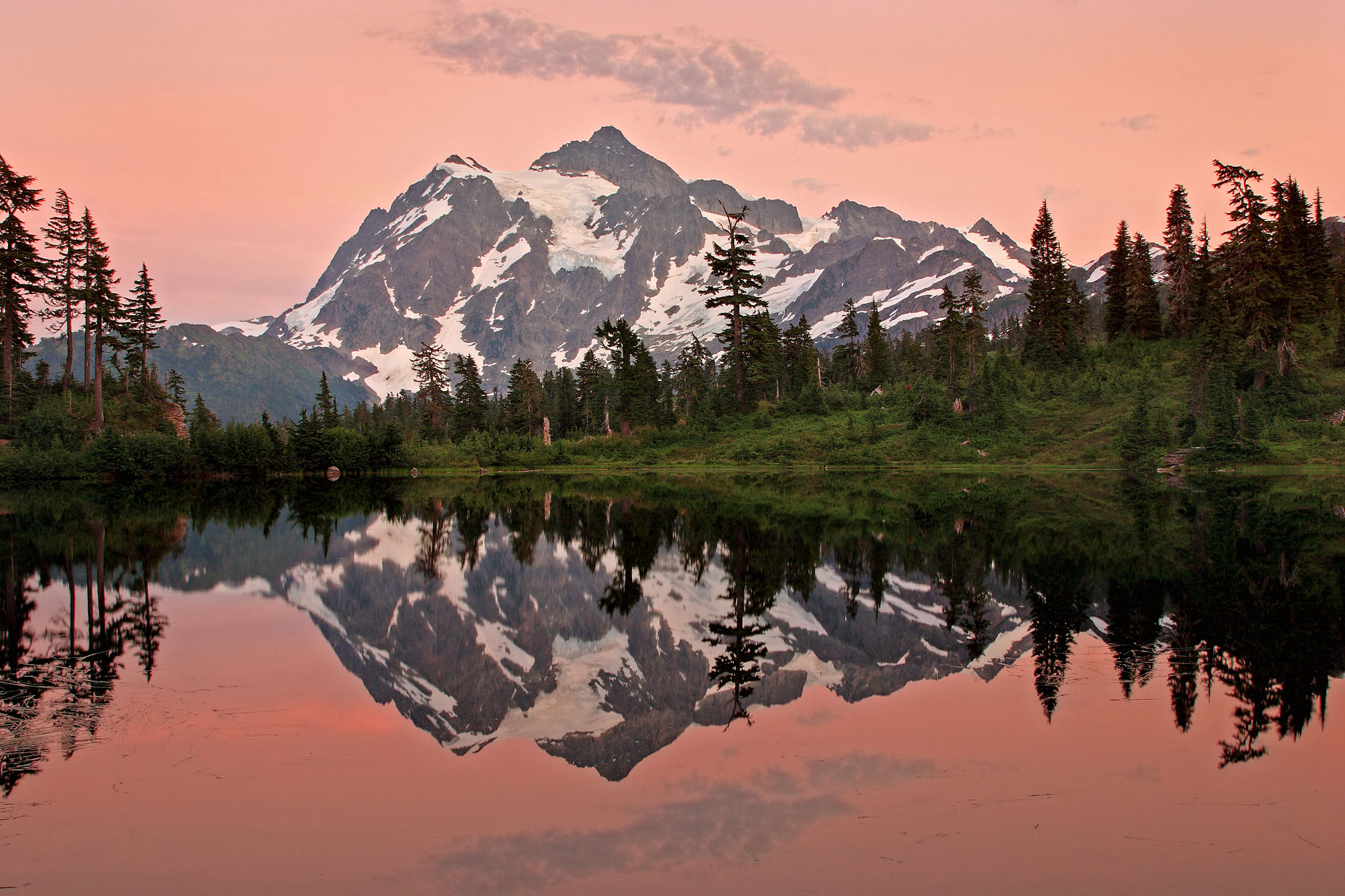 Mount Shuksan is reflected during twilight in Picture Lake in the North Cascades in Washington