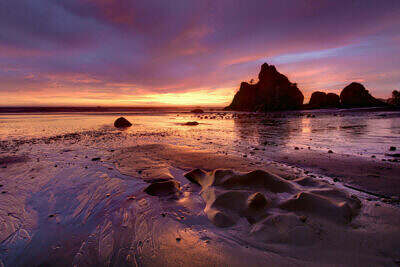 Sea stacks at Ruby Beach along the Pacific coastline of Olympic in Washington in the backlight of sunset