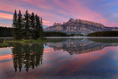 Mount Rundle is reflected at sunrise in Two Jack Lake near Banff in the Canadian Rocky Mountains.