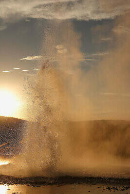 Plume Geyser in the Upper Geyser Basin of Yellowstone ejects millions of spinning water droplets backlit by the sun